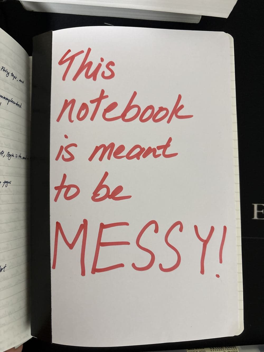 A notebook cover with the words "This notebook is meant to be MESSY!" scribbled in large red marker